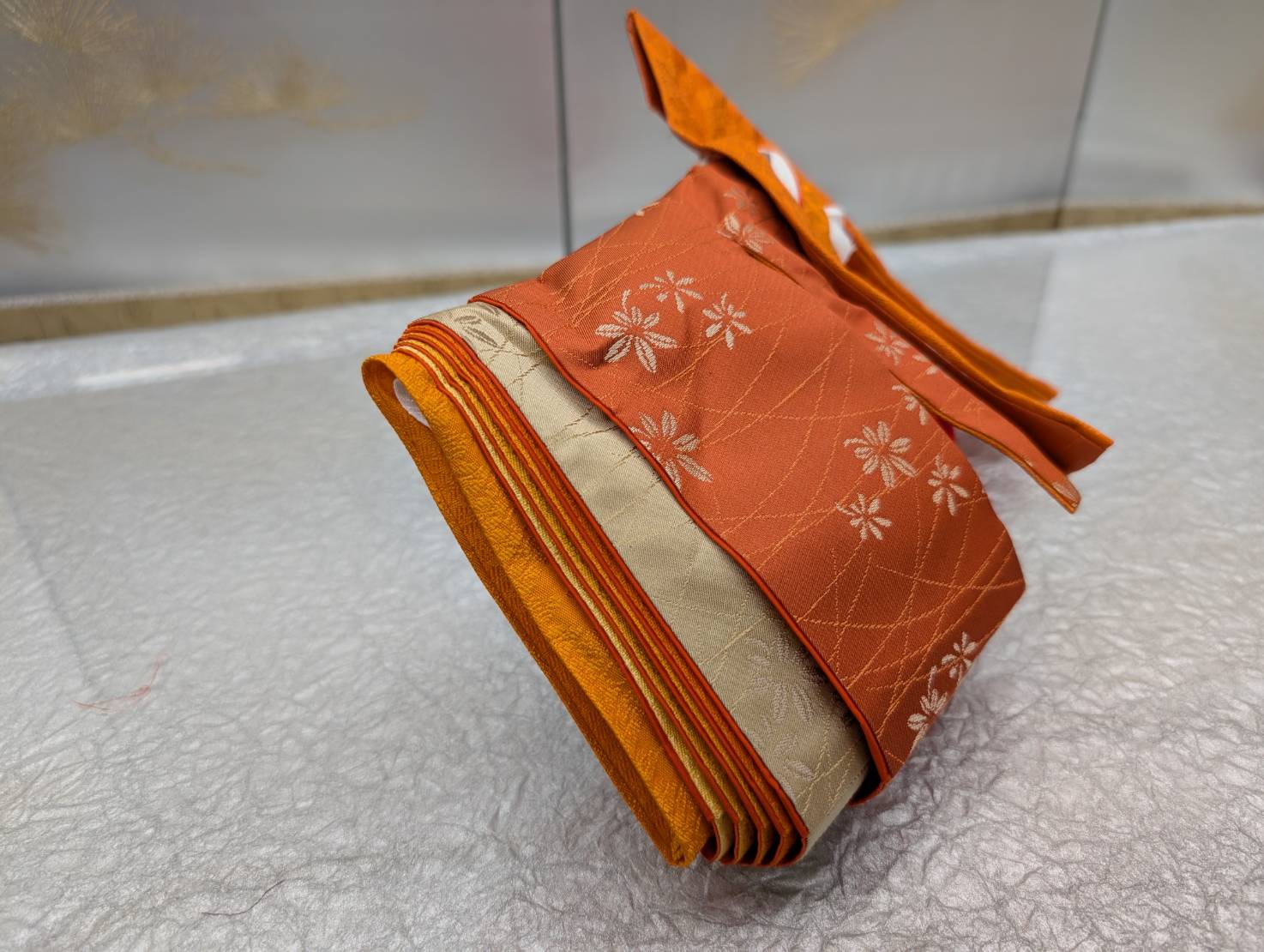 An example costume for the experience: orange silk with floral patterns