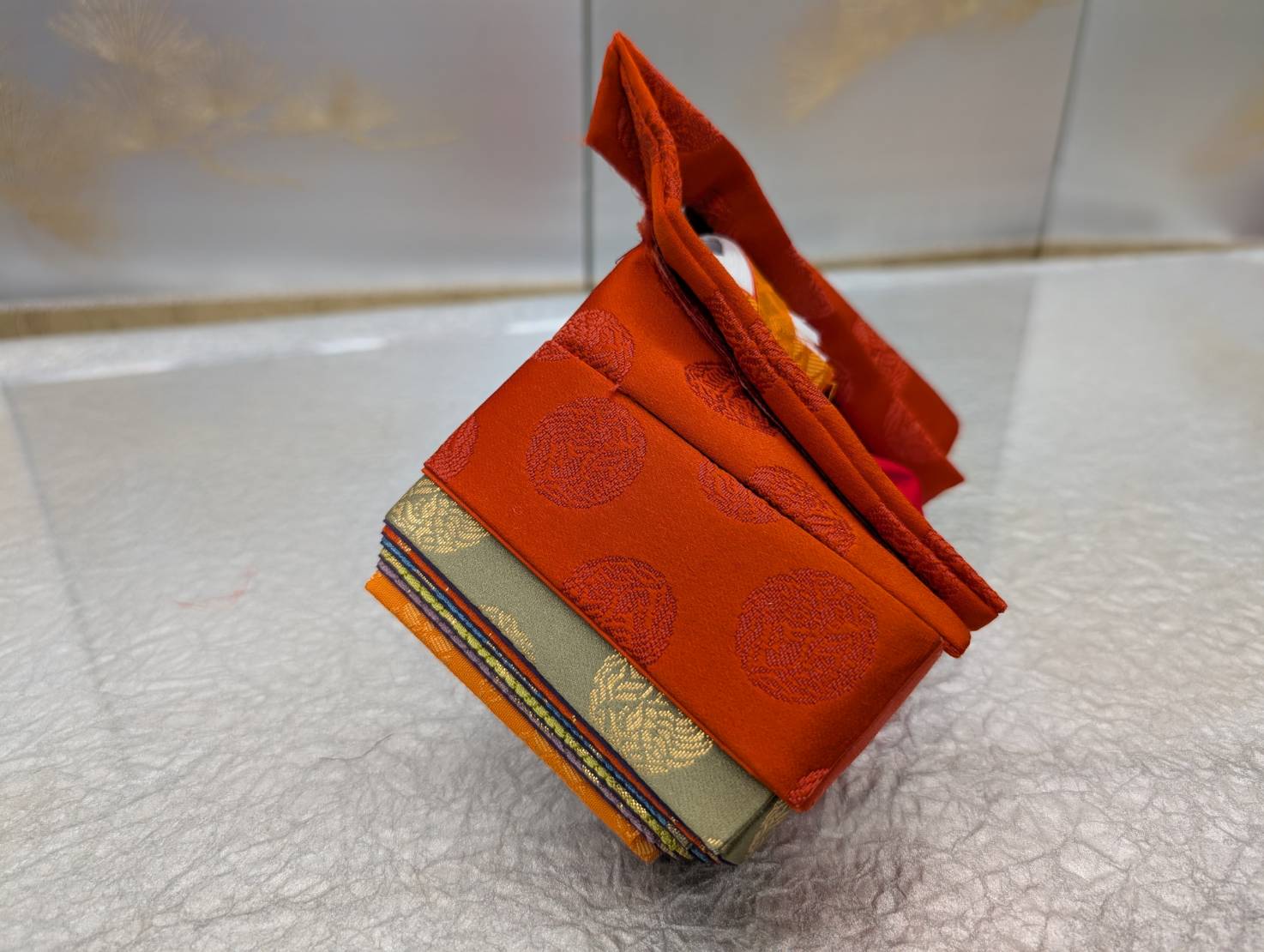 An example costume for the experience: vermilion silk with round crest patterns
