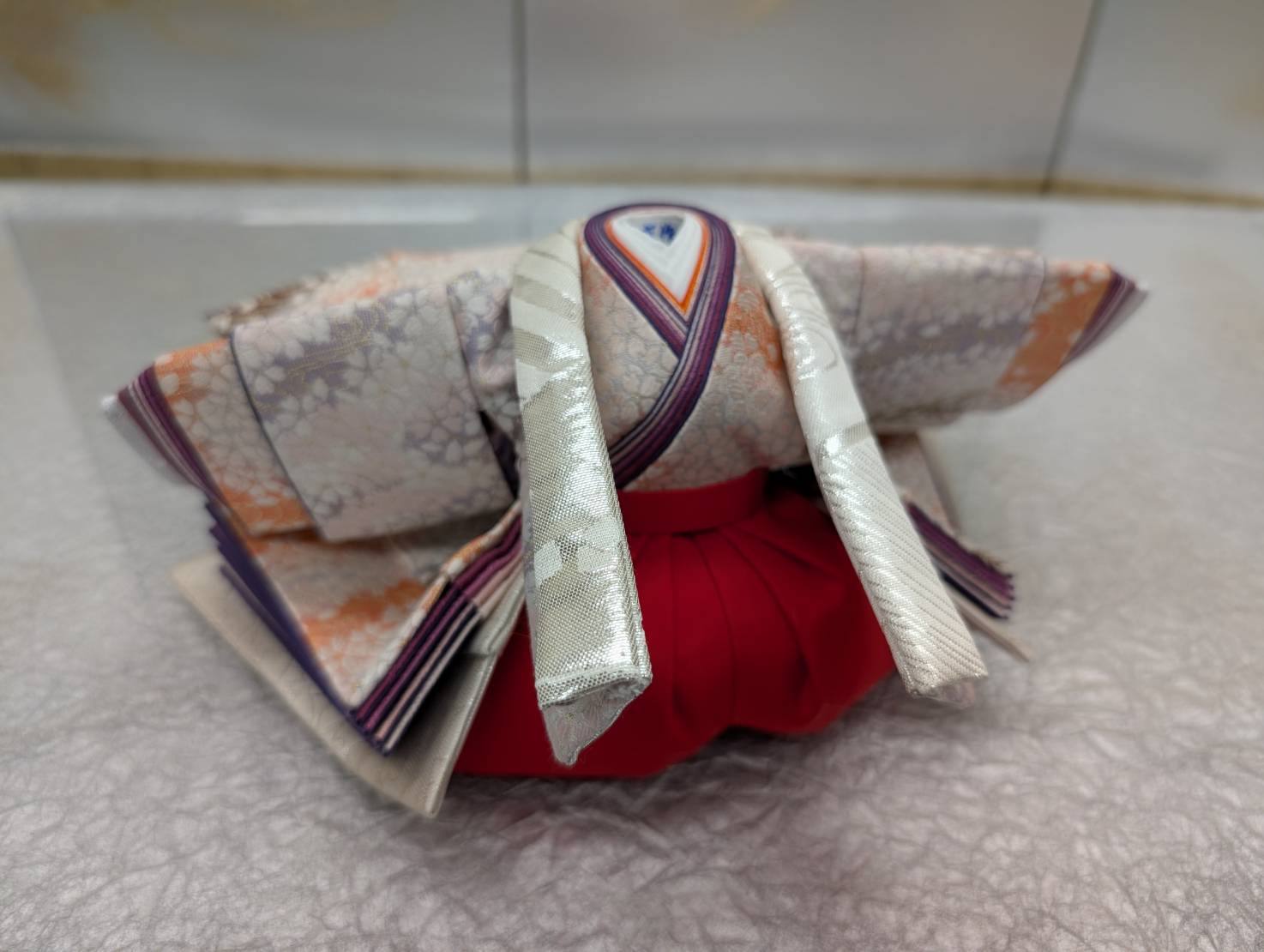 The fully dressed hina doll costume seen from behind, before the head is attached